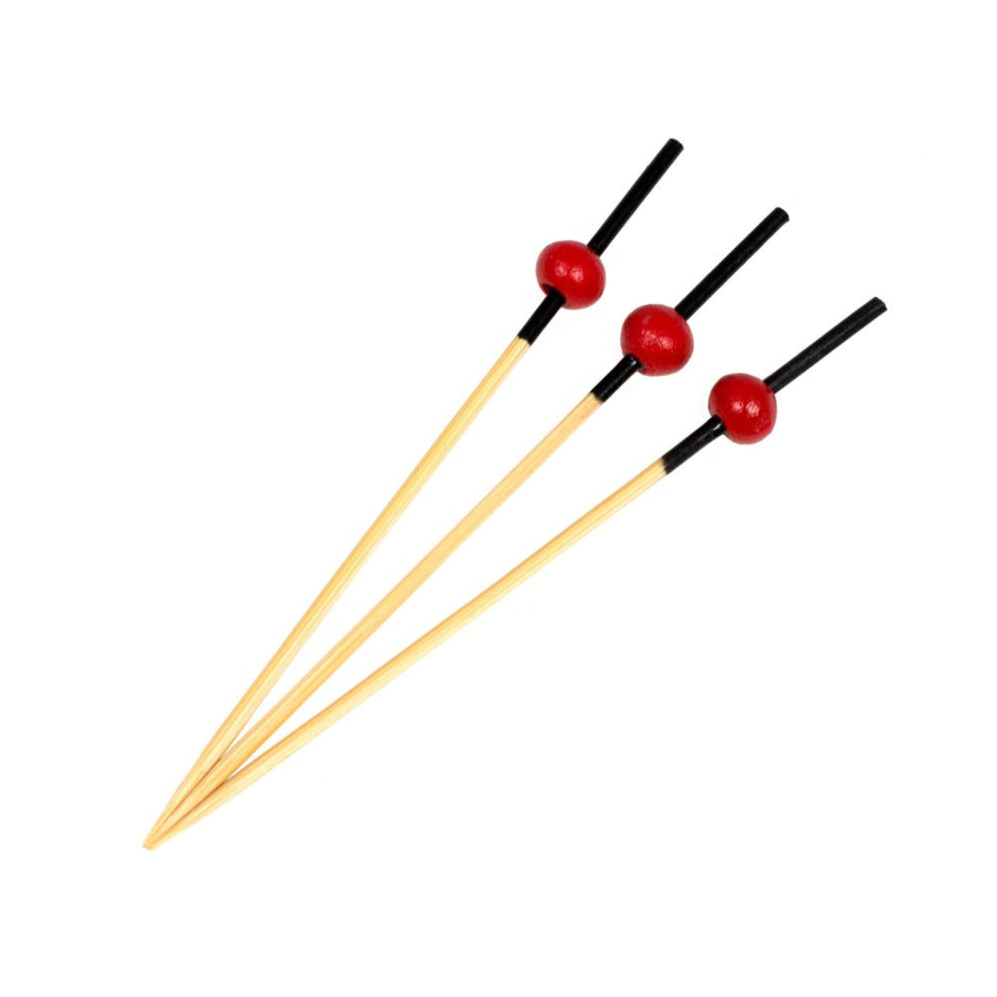 A set of bamboo cocktail picks with red ball garnishes.